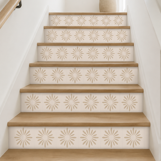 A staircase with light wood treads and patterned cream-and-beige risers, shown in a bright interior with a potted plant at the top.